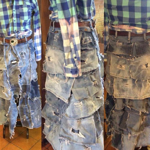 20204 Destroyed Denim Bustle Skirt is made from hand distressed and otherwise broken in and worn jeans. The waistband is also from worn jeans. Specify your waist size and length when ordering.